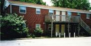 Vail Apartments in Carbondale are  two story red brick facade student rentals. 